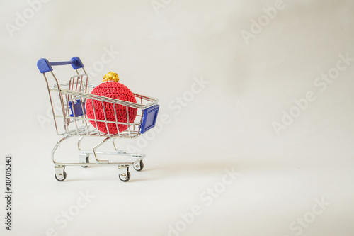 Christmas kni ornament in shopping cart. Christmas minimalism concept photo