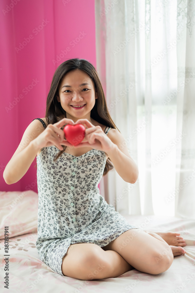 Beautiful pregnant woman hold red heart on bed Beautiful pregnant woman hold red heart on bed