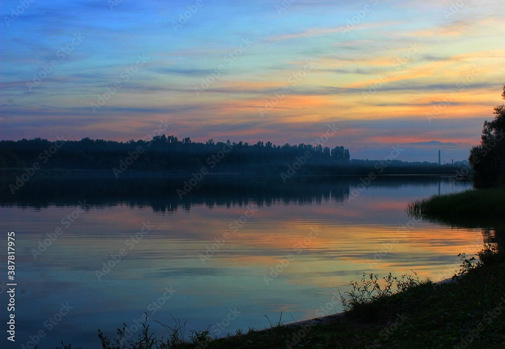 Naklejka premium sunset over the river