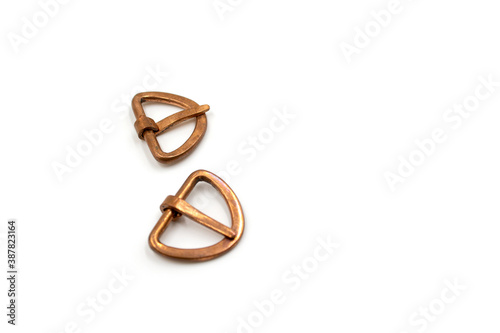 Isolated photos of medieval copper buckles