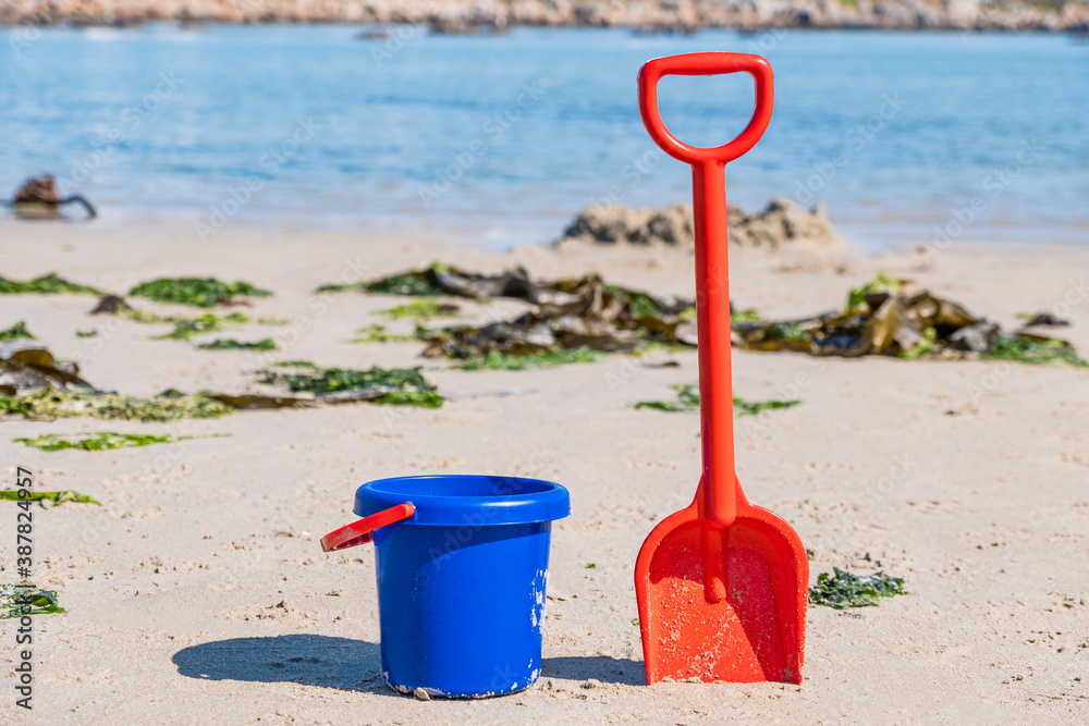 bucket and spade on a beach on a hot day bucket and spade on a beach on a hot day