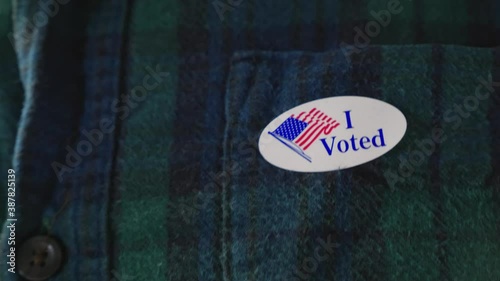 Man puts I Voted Sticker on Clothing After voting in American Election