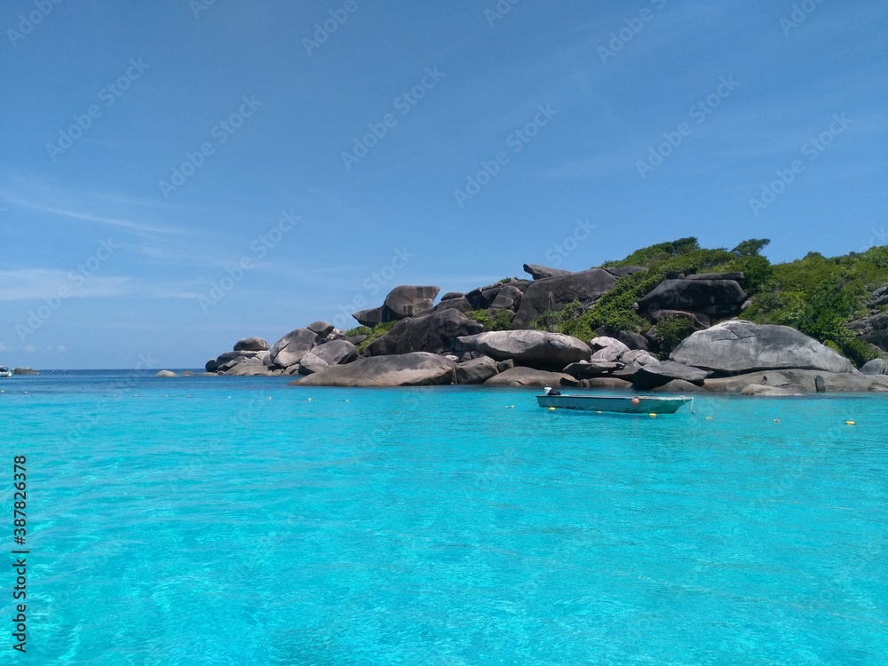 Gorgeous view of Similan islands with turquoise water and light blue sky.