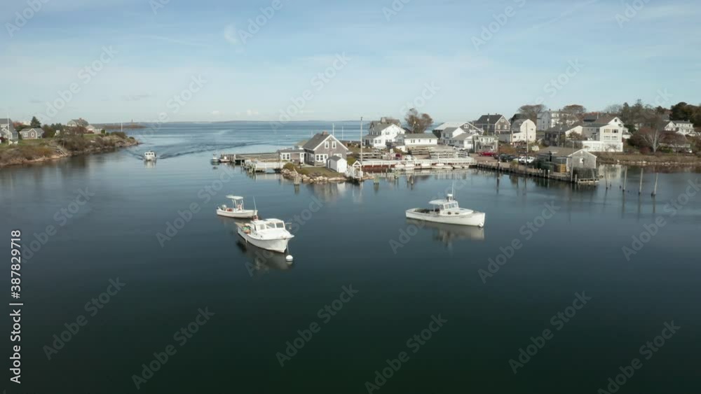 Coastal fishing village with boats in large tide pool, drone shot Coastal fishing village with boats in large tide pool, drone shot
