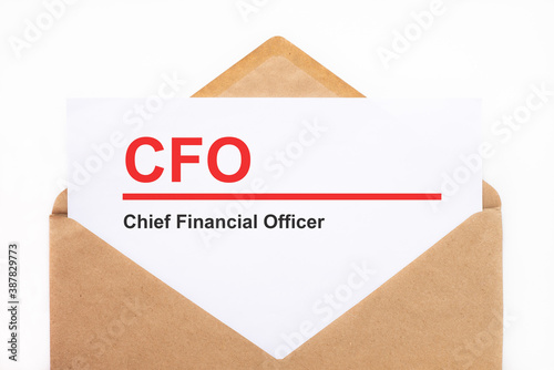 A white sheet with the text cfo lies in an open craft envelope on a white background with copy space. Business concept image