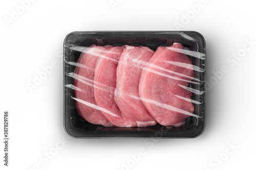 Fényképezés Sealable black plastic tray with raw meat schnitzels top-view