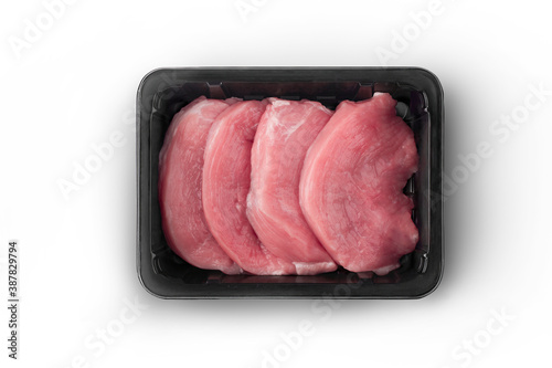 Obraz na płótnie Opened black plastic tray with raw meat schnitzels top-view
