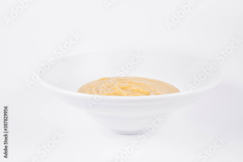 Pumpkin soup on a plate on a white background