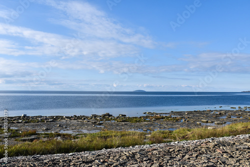 Flat rocks coast with the swedish island Bla Jungfrun in the horizon photo