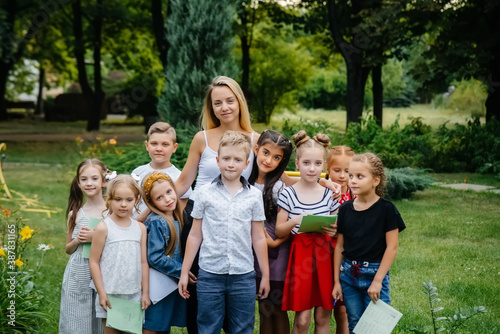 A teacher teaches a class of children in an outdoor Park. Back to school, learning during the pandemic