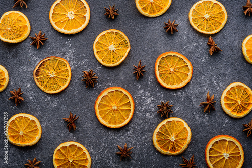 dried orange slices with star anise on gray background, kitchen background, top view, citrus composition