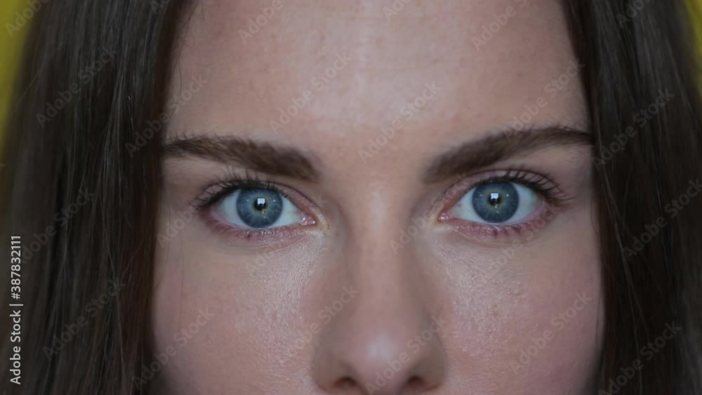 Woman open blue eyes. Close up of female face with wide blue eyes. Brunette woman portrait. Beautiful female macro. Attractive eyes looking camera. Perfect model face Woman open blue eyes. Close up of female face with wide blue eyes. Brunette woman portrait. Beautiful female macro. Attractive eyes looking camera. Perfect model face