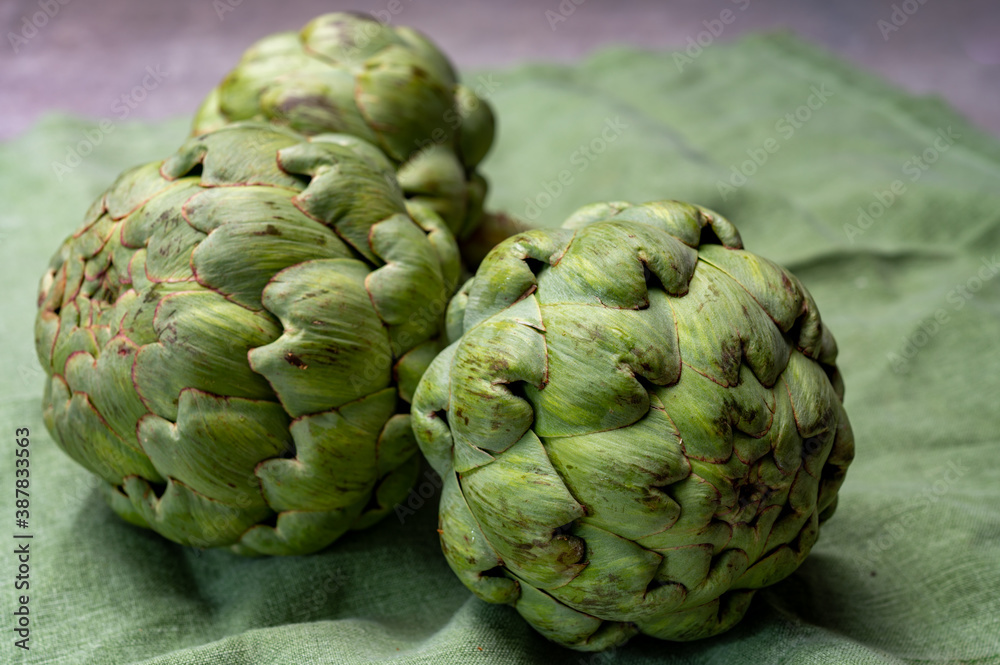 Big ripe uncooked green globe artichoks vegetables Big ripe uncooked green globe artichoks vegetables