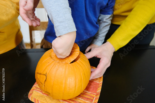 Family detail preparing a halloween pumpkin