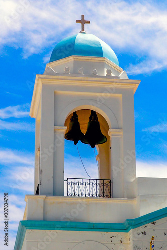 Bell tower of the Orthodox Church of Saint George in the old town of Chora sur Andros, famous Cyclades island in the heart of the Aegean Sea photo