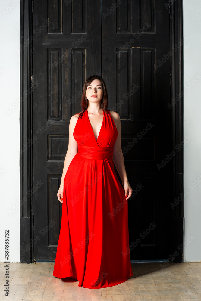 Beautiful sexy woman in red dress in interior Beautiful sexy woman in red dress in interior