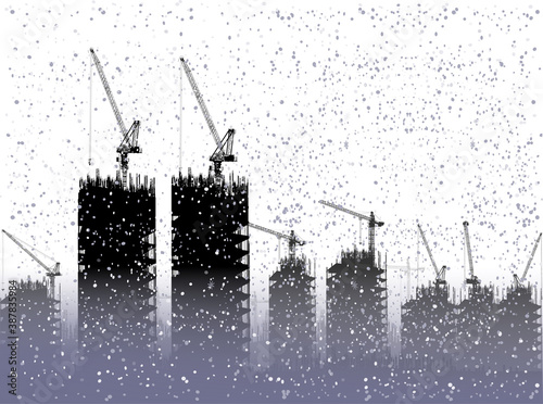 tower cranes and unfinished buildings under snow on white background