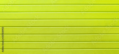 yellow pattern of horizontal lines, covering, background, abstraction, close-up. web panorama banner with copy space.