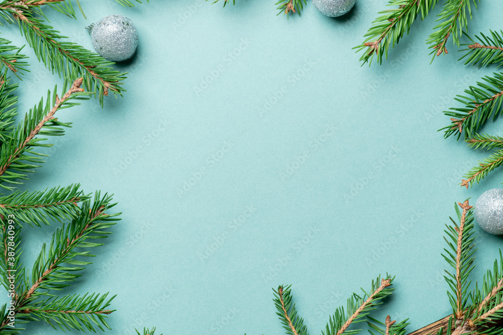 Fir, spruce branches and Christmas tree toys on green background with copy space Fir, spruce branches and Christmas tree toys on green background with copy space