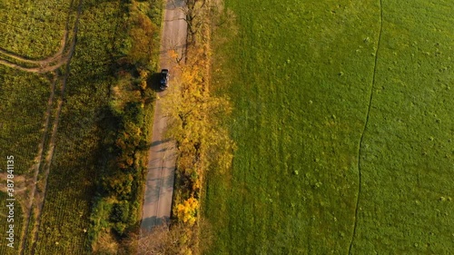 Beautiffull Autumn drone fly over the road with car driving by photo