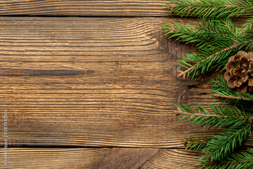 Fir, spruce branches on brown wooden background with copy space Fir, spruce branches on brown wooden background with copy space