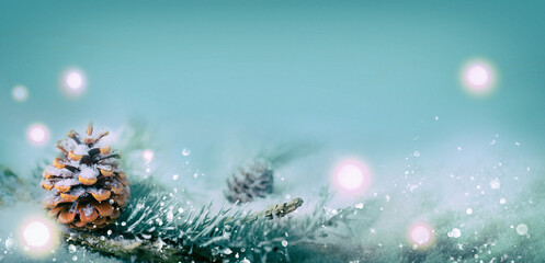 Winter Christmas background with magic lights, pine cone in snow landscape
