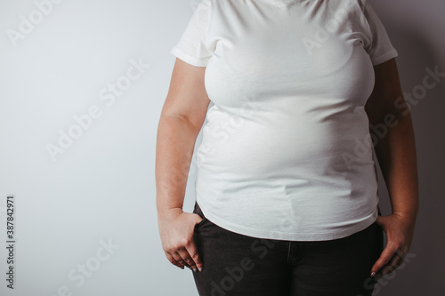 Overweight woman with big belly, copy space