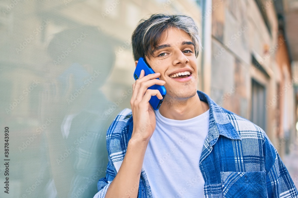 Young hispanic man smiling happy talking on the smartphone at the city. Young hispanic man smiling happy talking on the smartphone at the city.