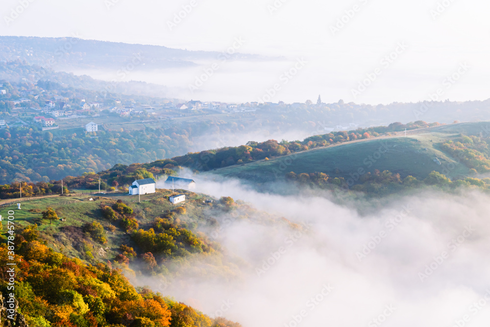 Panoramic view down to Saint George monastery in Kojori surounded by mist and clouds. Religion and sait places in Georgia concept.