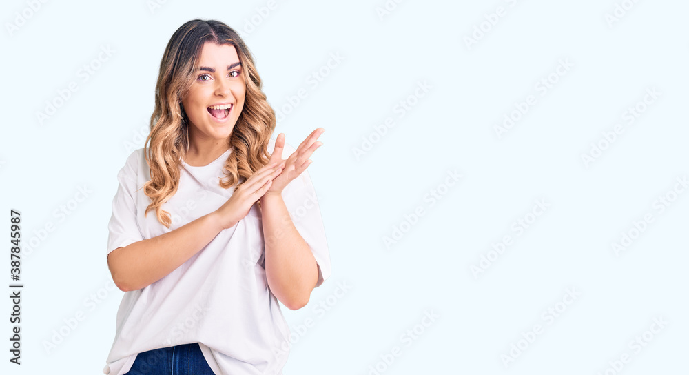 Young caucasian woman wearing casual clothes clapping and applauding happy and joyful, smiling proud hands together