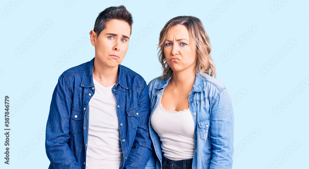 Couple of women wearing casual clothes depressed and worry for distress, crying angry and afraid. sad expression. Couple of women wearing casual clothes depressed and worry for distress, crying angry and afraid. sad expression.