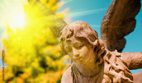 Guardian angel statue in sunlight . Fragment of ancient statue.