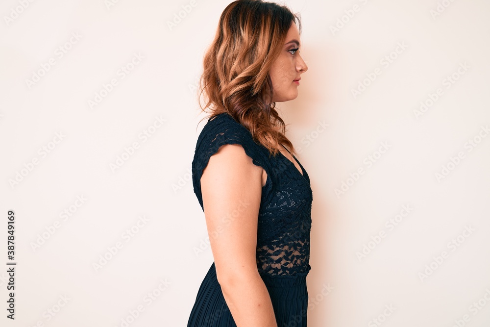 Young beautiful caucasian woman wearing elegant clothes looking to side, relax profile pose with natural face with confident smile. Young beautiful caucasian woman wearing elegant clothes looking to side, relax profile pose with natural face with confident smile.