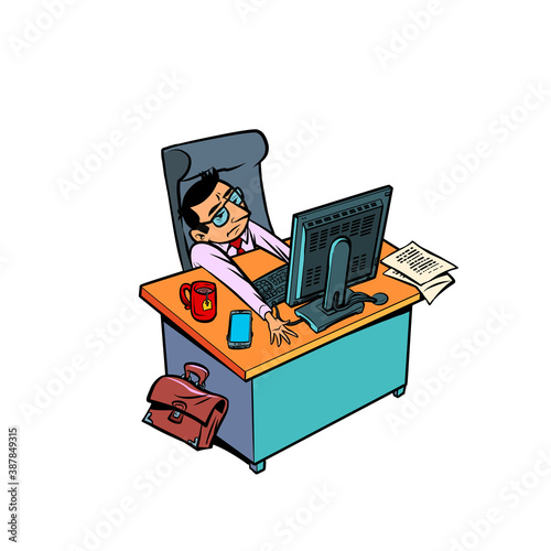 sleepy tired male businessman works at an office workplace at a computer