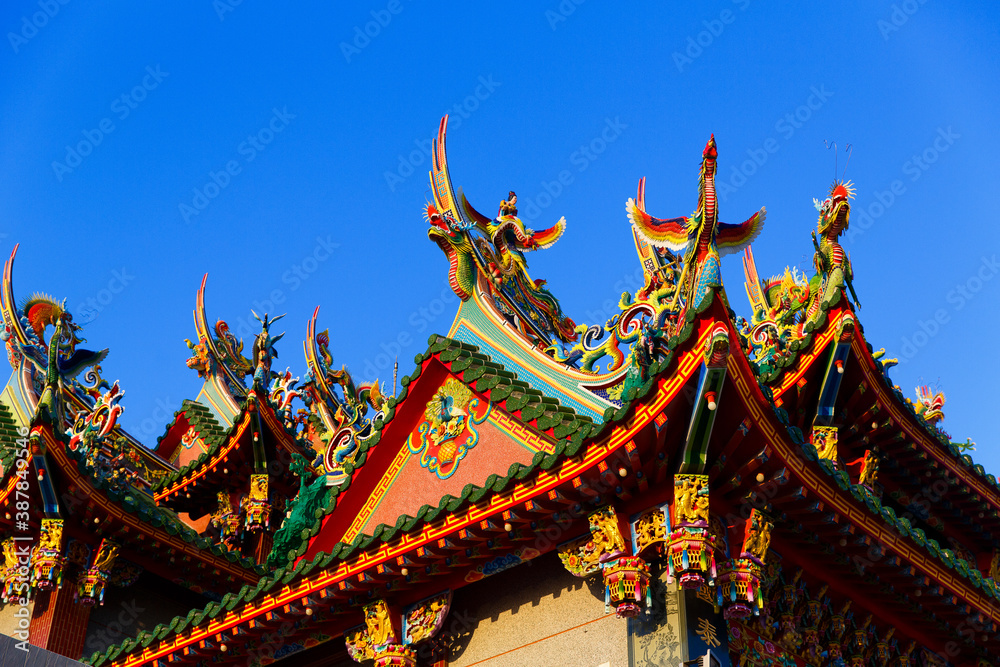 Tainan, Taiwan, October 12, 2019 Colorful roofs of a Taiwanese temple decorated with sculptures of sacred animals ( dragons and lions) in traditional mosaic art