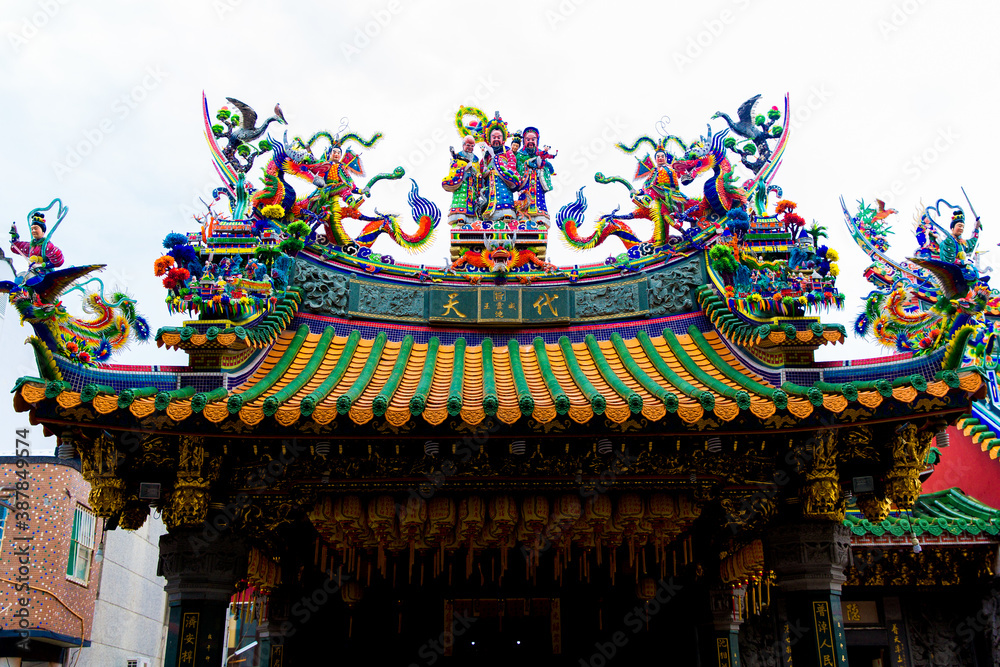 Tainan, Taiwan, October 12, 2019 Colorful roofs of a Taiwanese temple decorated with sculptures of sacred animals, dragons, lions and deities in traditional mosaic art