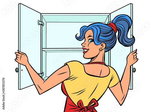 A woman opens the cupboard