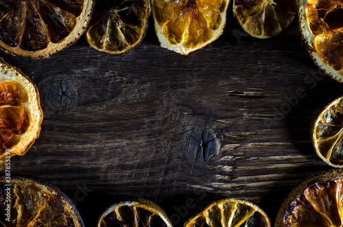dried slices of citrus fruits on the black background with copy space