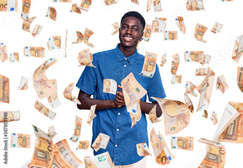 Young african american man wearing casual clothes with hands together and crossed fingers smiling relaxed and cheerful. success and optimistic photo