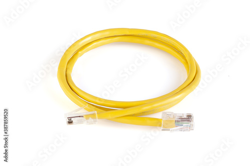 Network ethernet cable with RJ45 connectors isolated on white background. UTP Cable or LAN Cable. yellow color on white background. Close up