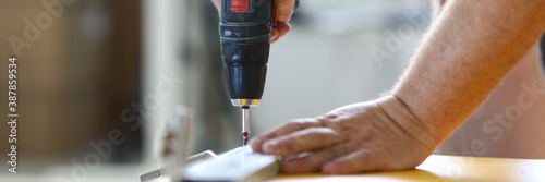 фотографія Hand with screwdriver fasten details with close-up