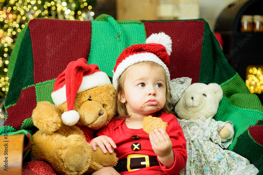 Portrait of a cute baby in Christmas hat. New Year child. Kid enjoy the holiday. Portrait of a cute baby in Christmas hat. New Year child. Kid enjoy the holiday.