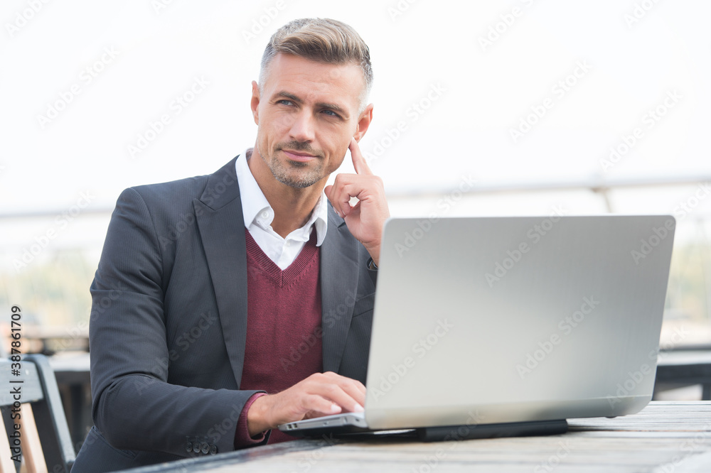 Freelance worker in business casual work online in laptop computer in cyber cafe, freelancing Freelance worker in business casual work online in laptop computer in cyber cafe, freelancing