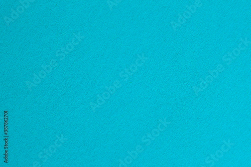 Texture of artistic paper, bright blue cerulean color. Fashionable background photo
