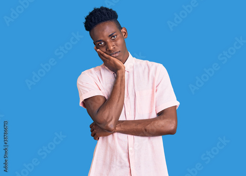 Young african american man wearing casual clothes thinking looking tired and bored with depression problems with crossed arms.