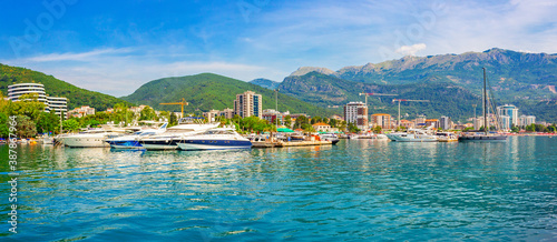 Summer seascape, Budva city on Adriatic sea coastline and marina with yachts in the foreground, Montenegro