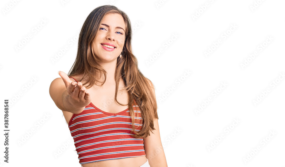 Beautiful caucasian young woman wearing casual clothes smiling friendly offering handshake as greeting and welcoming. successful business. Beautiful caucasian young woman wearing casual clothes smiling friendly offering handshake as greeting and welcoming. successful business.