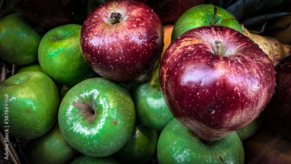 red apples in a basket. green and red apples.