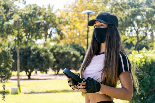 sporty woman with headphones at the park