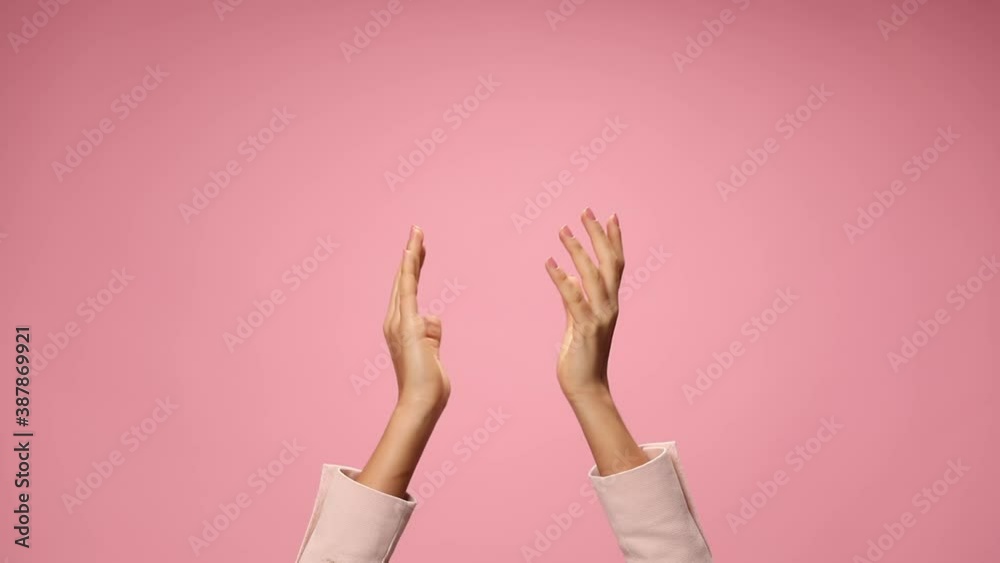 woman's hands clapping, pointing fingers and applauding on pink background woman's hands clapping, pointing fingers and applauding on pink background